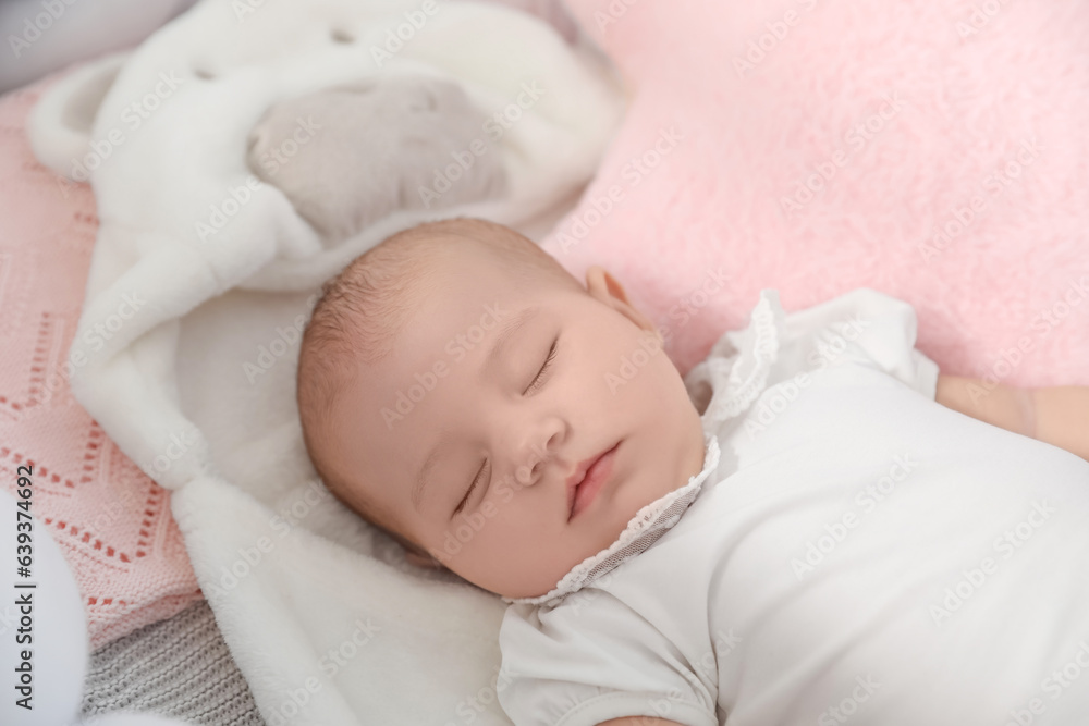 Cute baby lying in crib, closeup