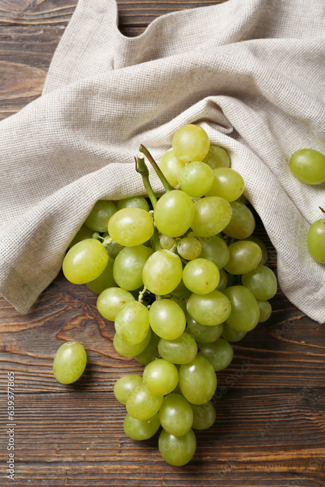 Sweet green grapes on wooden background