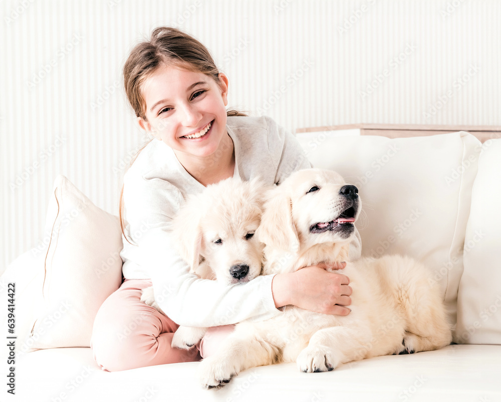 Smiling girl hugging puppies