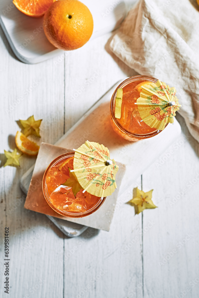 orange juice and oranges on white background