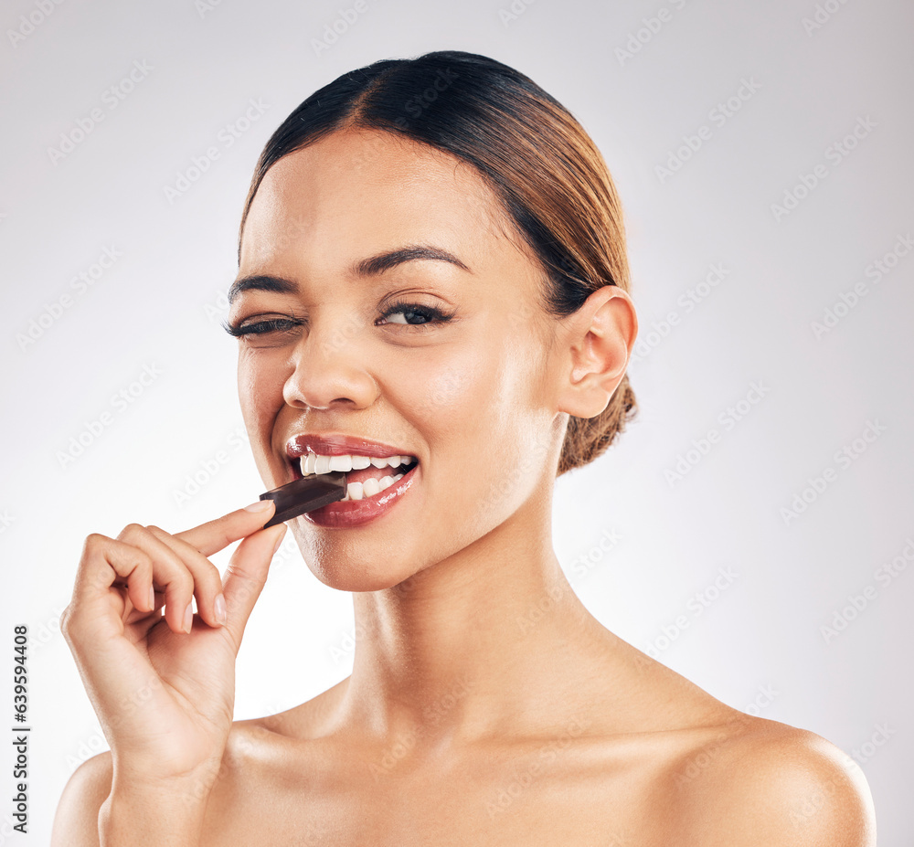 Chocolate, wink and portrait of woman in studio with diet, detox or sweet, unhealthy and snack on wh