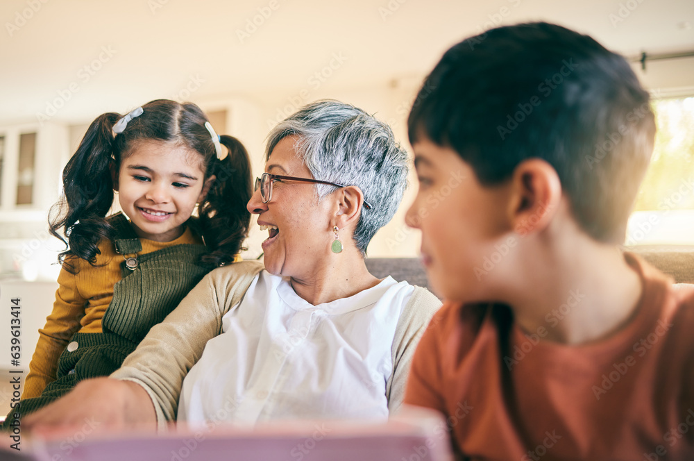 Happy kids, smile or grandma reading a book for learning, education or storytelling on sofa at home.