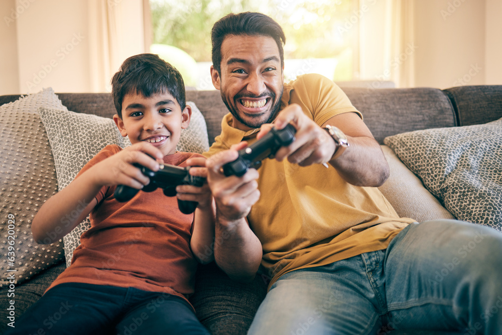 Family, fun and a boy gaming with his father on a sofa in the living room of their home together for