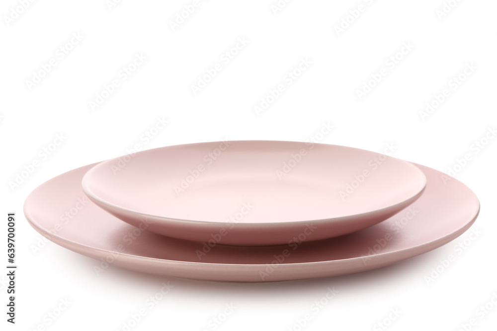 Pink ceramic plates on white background