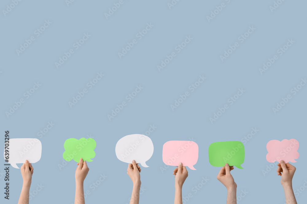 Female hands with speech bubbles on blue background