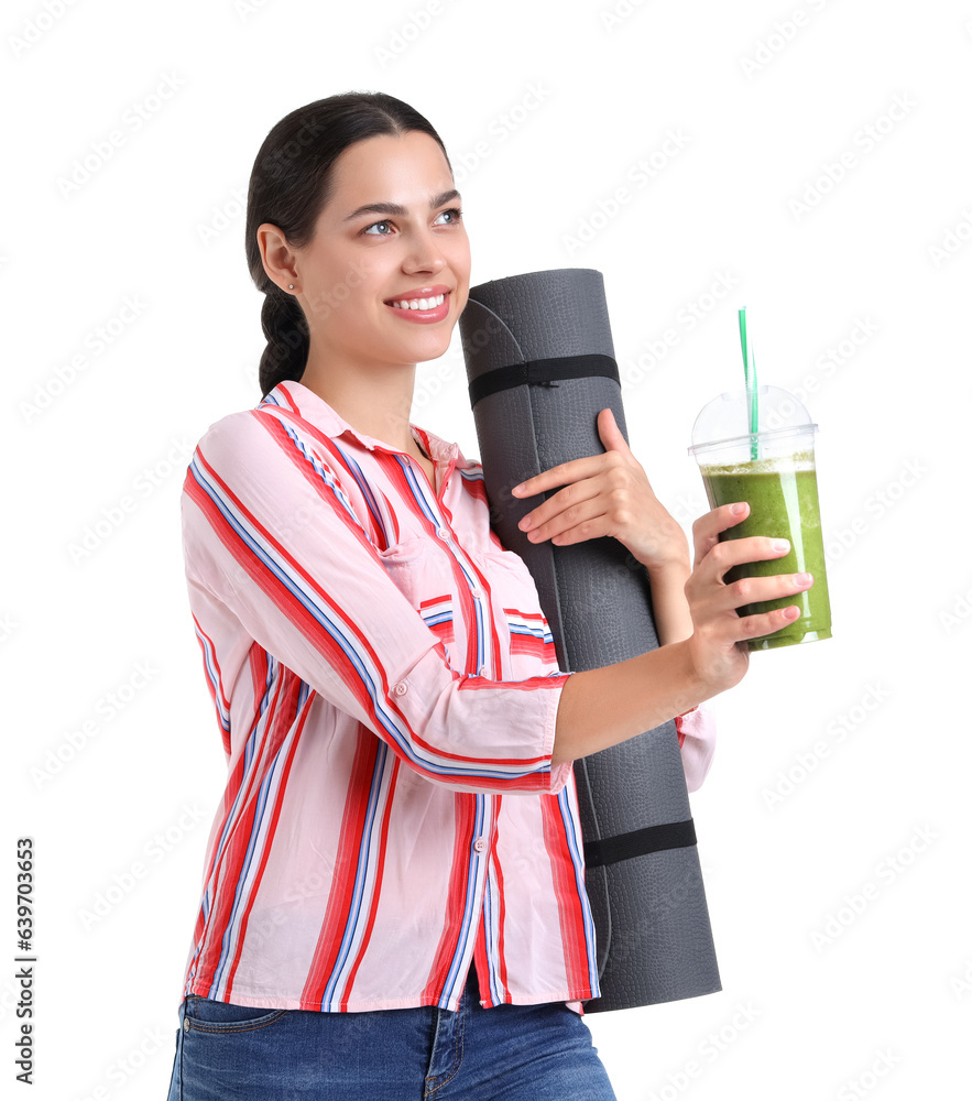 Young woman with healthy smoothie and fitness mat on white background