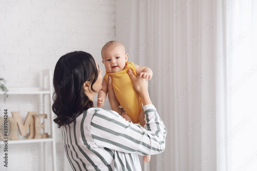 Young woman with her baby at home