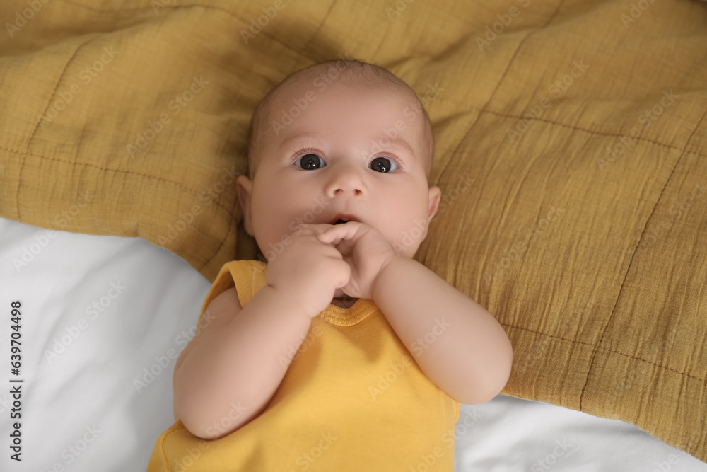 Cute baby lying on bed, closeup