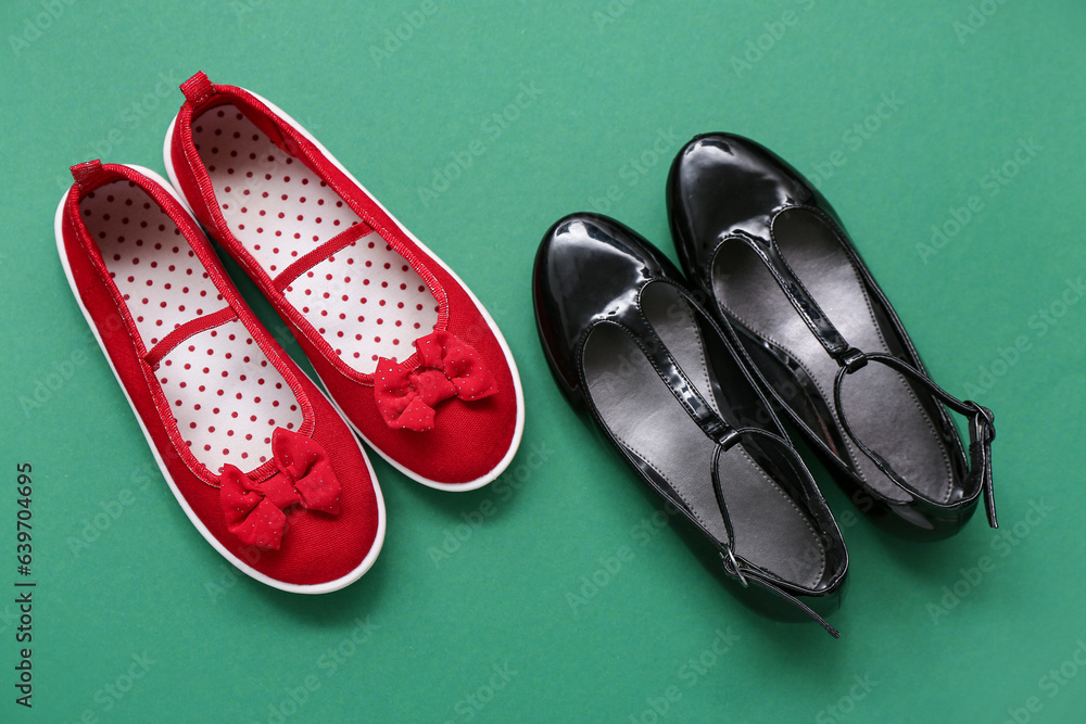 Stylish childs shoes on green background