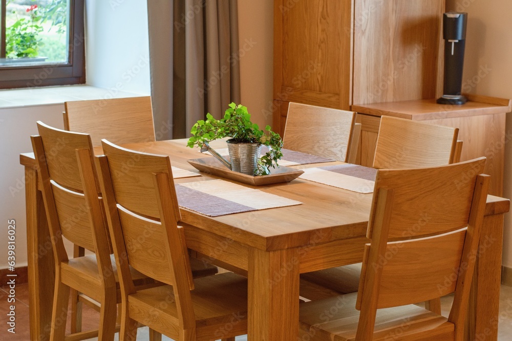 Solid wood kitchen furniture. Table and chairs, cozy home interior.