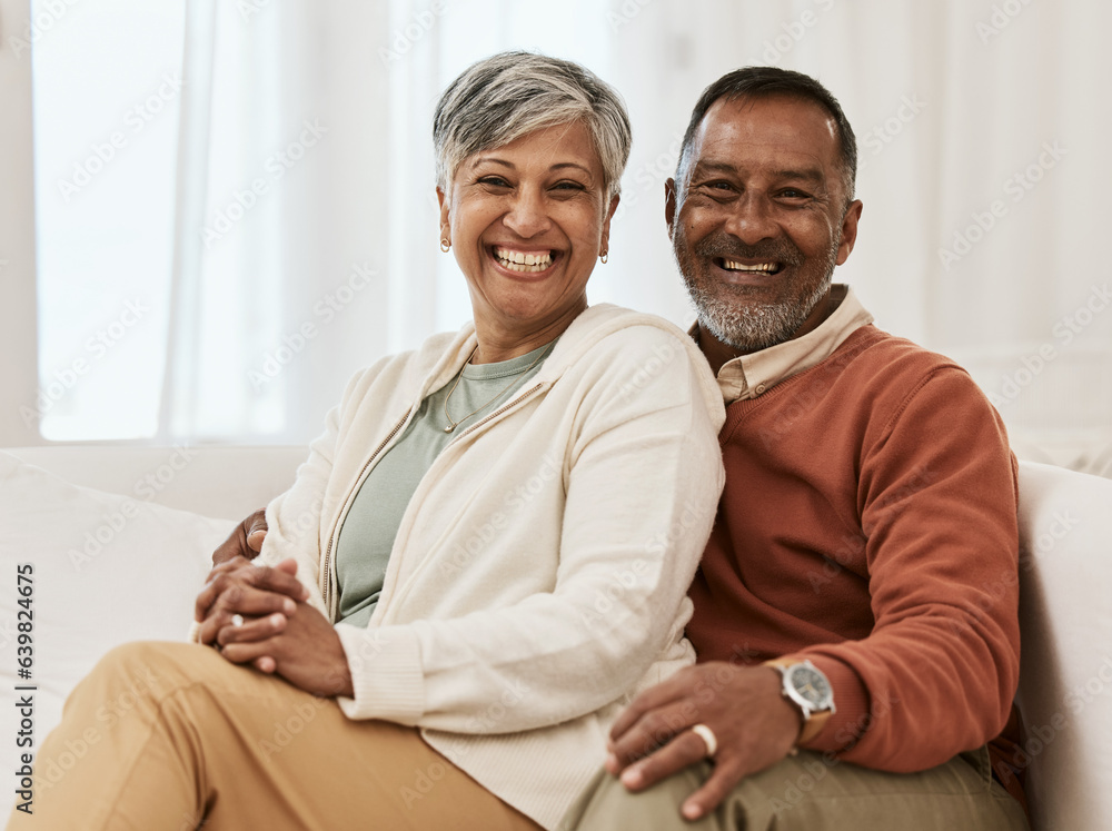 Happy, portrait and senior couple hug on sofa a living room relax, laugh and bonding in their home. 