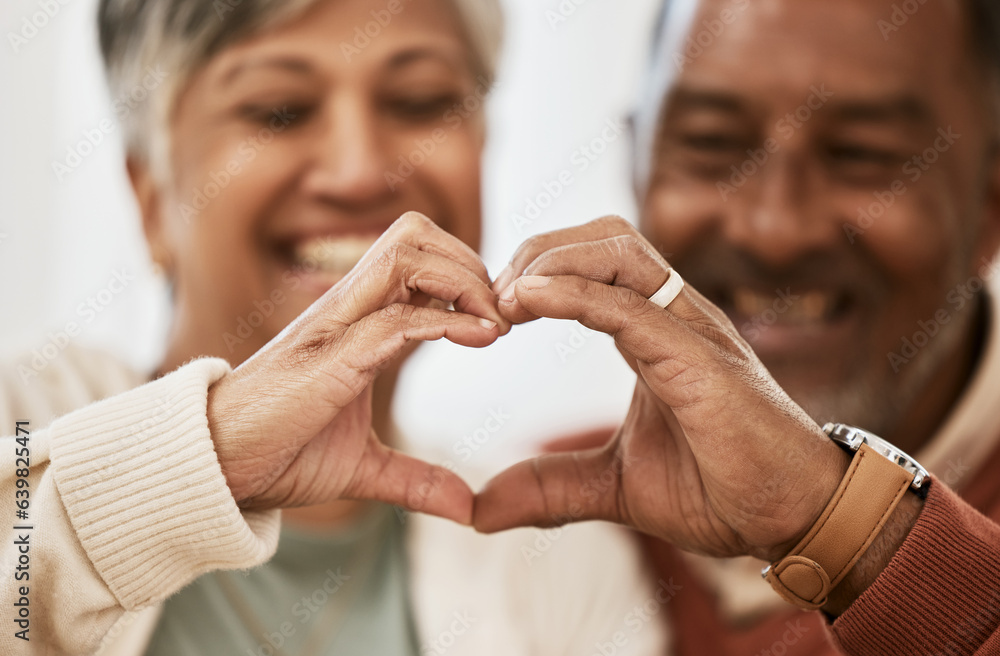 Heart, hands and happy senior couple with love, thank you sign or healthy gesture in their home toge