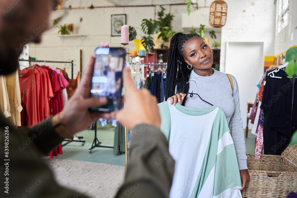 Shopping, photography and fashion with a black woman influencer in a clothes store as a brand ambass