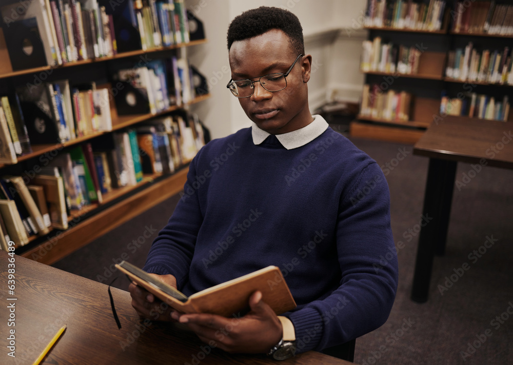 University, book and black man student reading and learning in a college for knowledge development. 