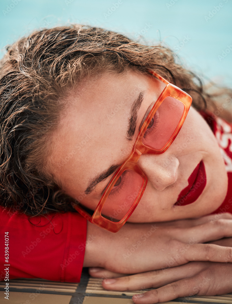 Face, summer and sunglasses with a hipster woman closeup in a swimming pool for safety or style. Fas