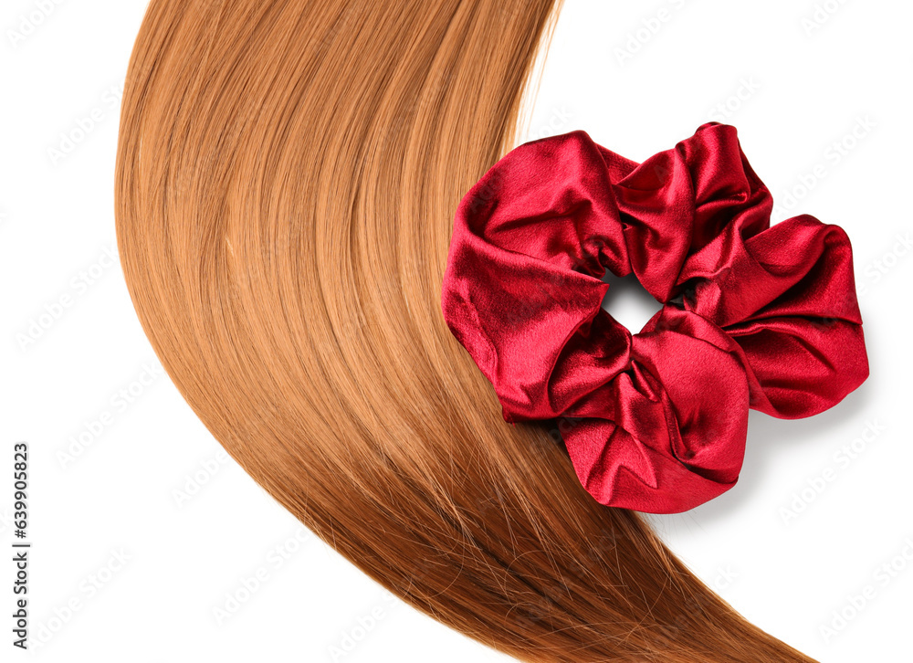 Hair strand and silk scrunchy on white background, closeup