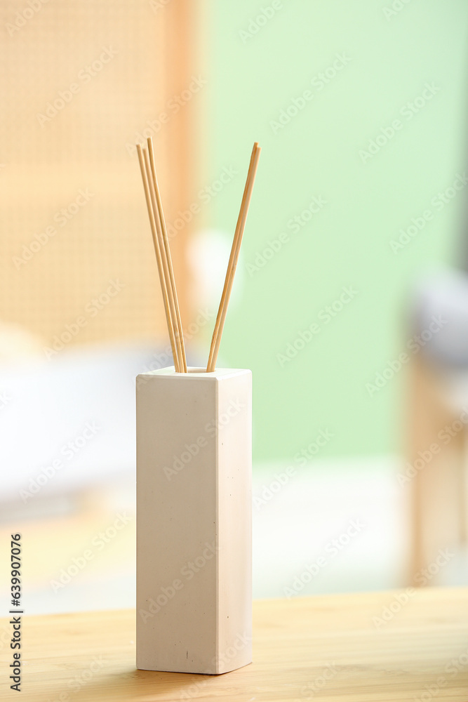 Bottle of reed diffuser on table, closeup