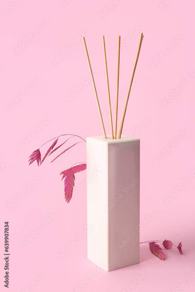 Floral reed diffuser on pink background