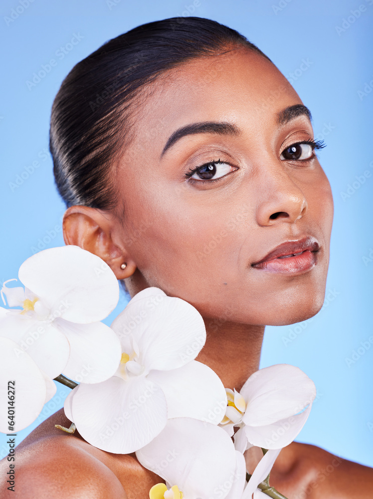 Flower, skincare and portrait of woman in studio for beauty, wellness and organic body care on blue 