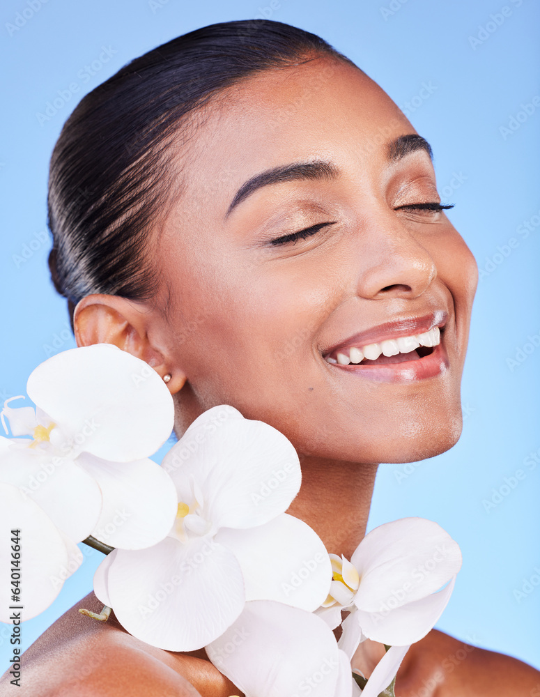 Skincare, flower and happy woman in studio for beauty, wellness and organic body care on blue backgr