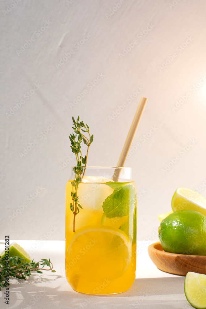 Drink with orange lemon and lime in glass transparent glasses on a concrete background. Lemonade wit