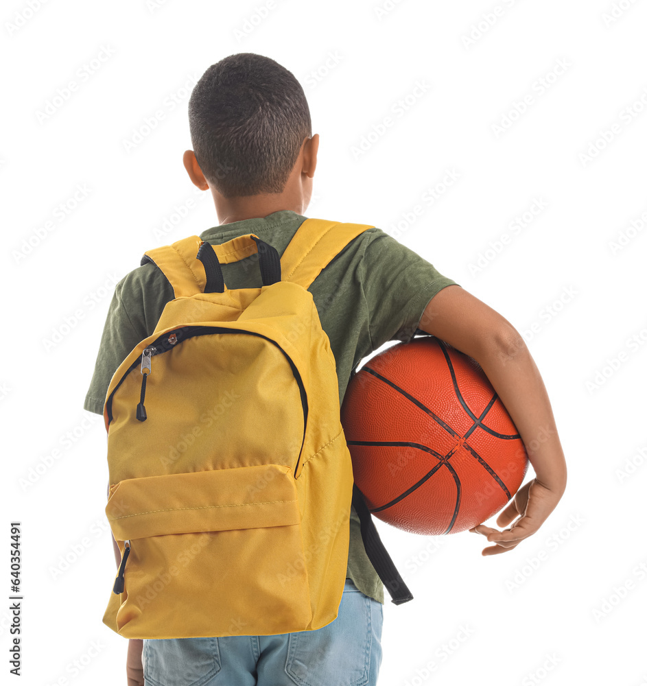 Little African-American schoolboy with ball and backpack on white background, back view