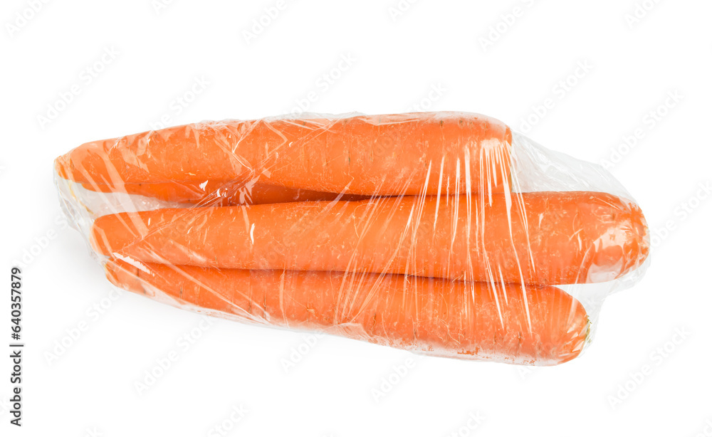 Fresh carrot wrapped in stretch wrap on white background