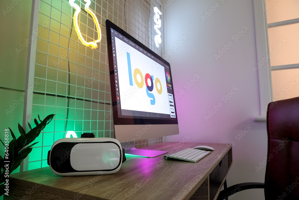 Table with modern computer and VR glasses in childrens bedroom