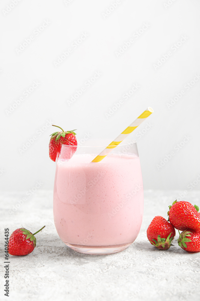 Glass of tasty strawberry smoothie on table