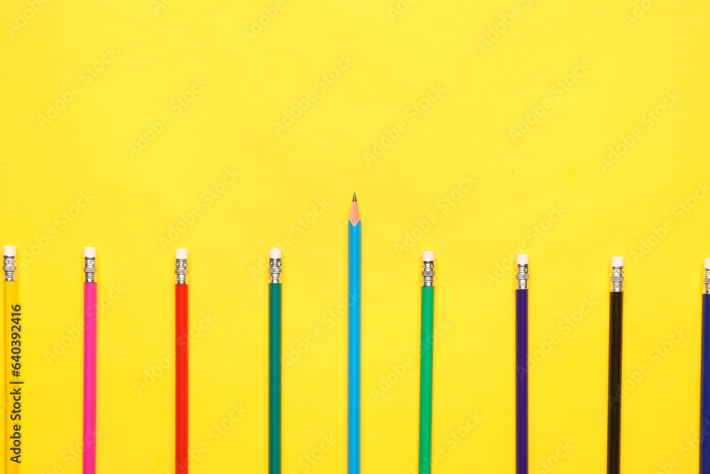 Group of colorful pencils on yellow background