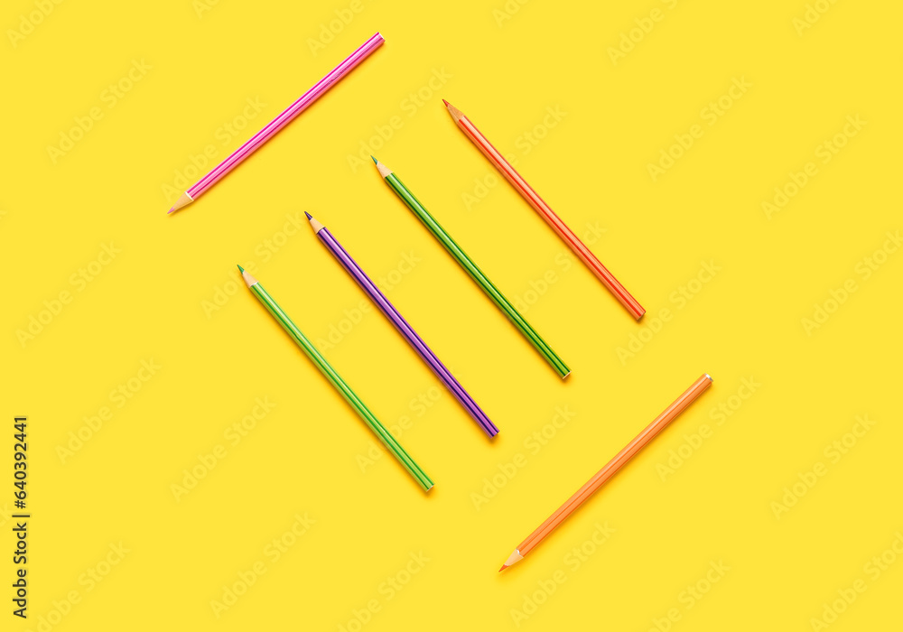 Group of colorful pencils on yellow background