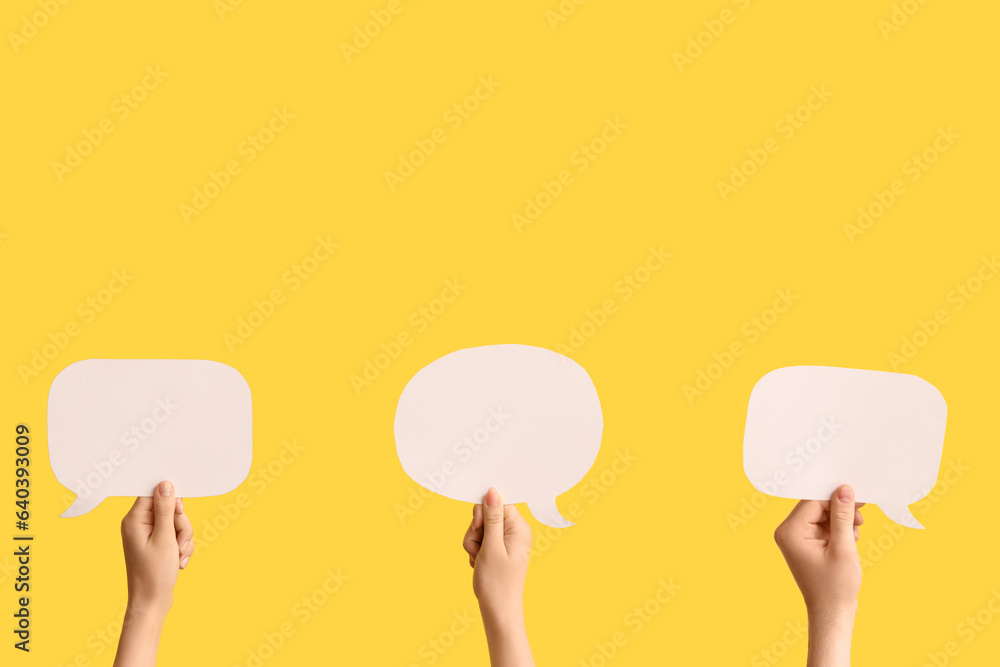 Different hands with speech bubbles on yellow background