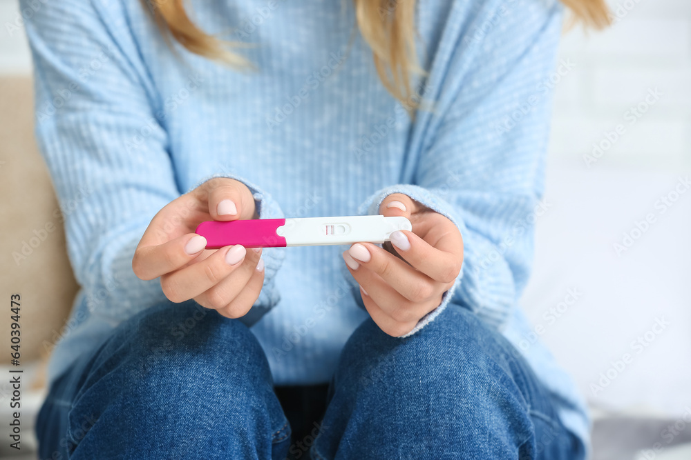 Woman with pregnant test, closeup