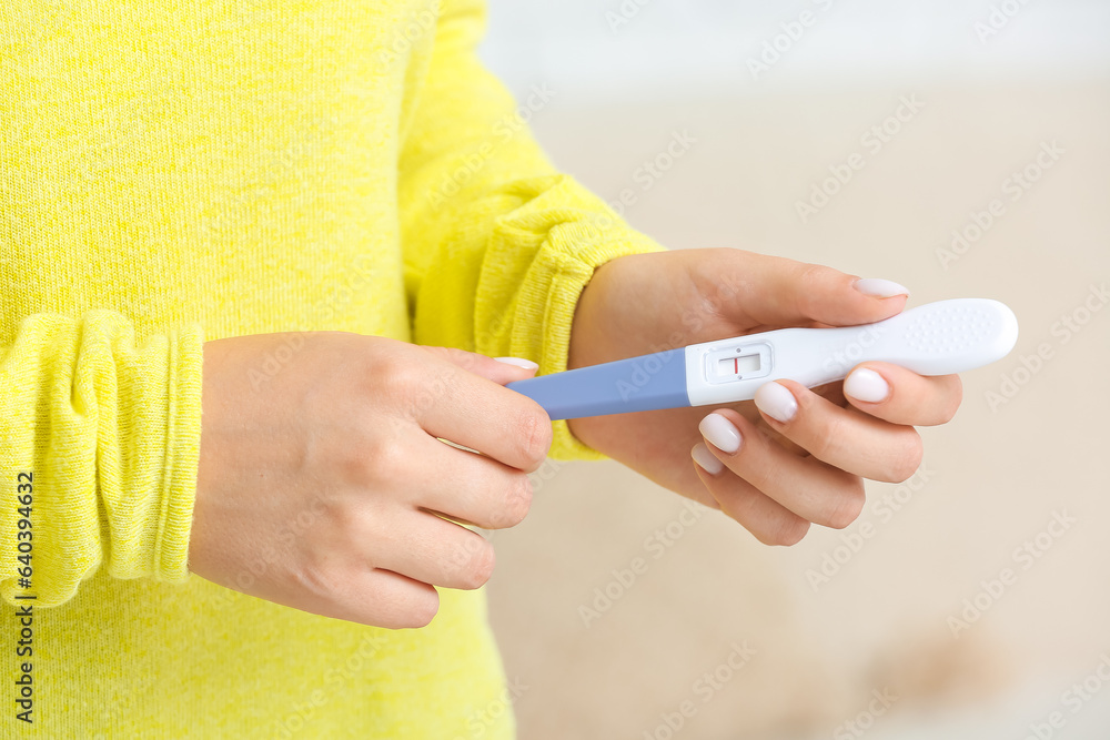 Woman with negative pregnancy test, closeup