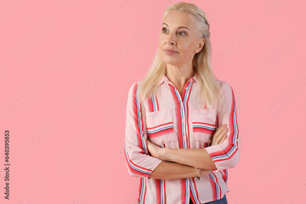 Mature woman on pink background