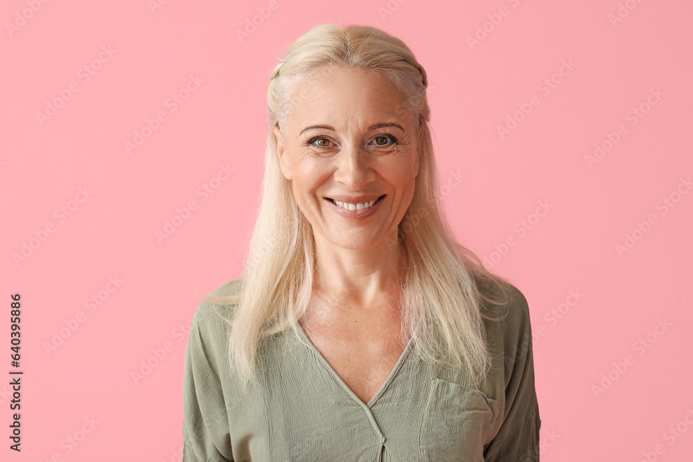 Mature woman on pink background, closeup