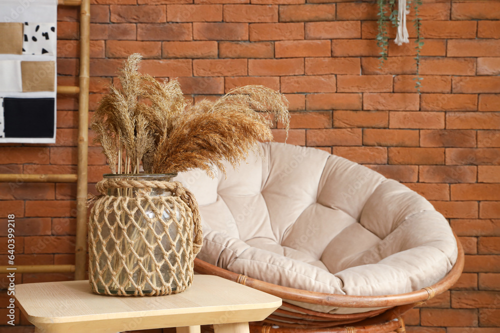 Vase with pampas grass on table in living room, closeup