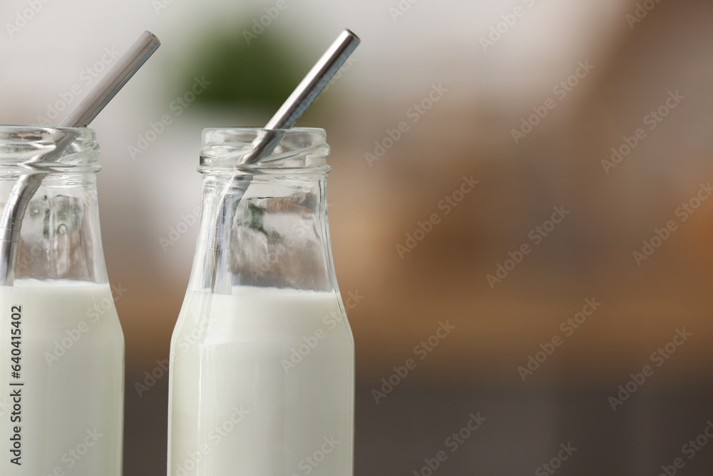 Bottles of fresh milk in kitchen, closeup