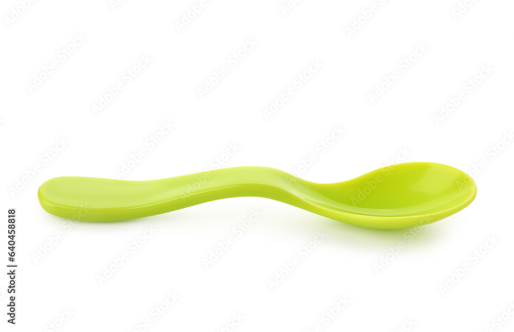 Green plastic spoon for baby on white background