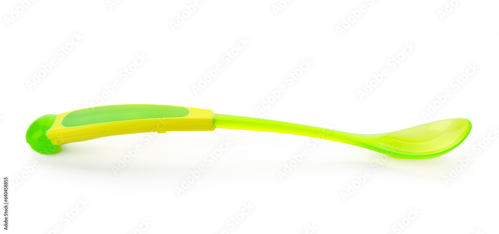 Green plastic spoon for baby isolated on white background