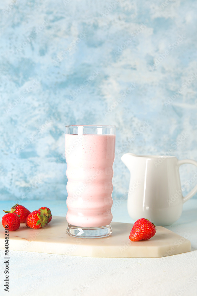 Glass of tasty strawberry smoothie on table