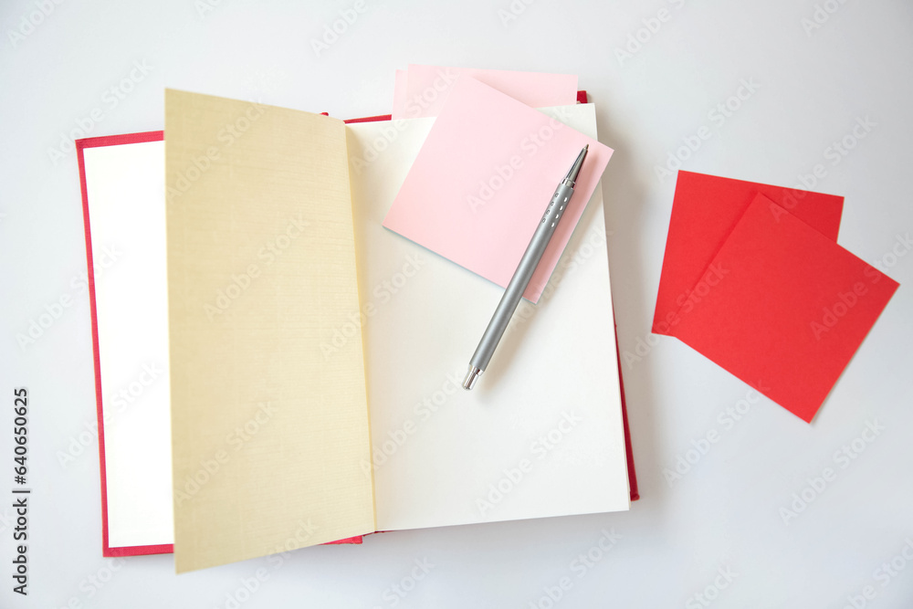 An open book with a red cover and stickers for notes is on the table. The theme is Education Day and