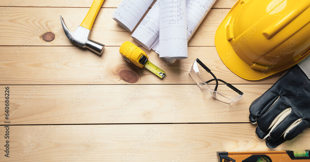 Work safety. Standard Construction site protective equipment on  top view wooden background, flat la