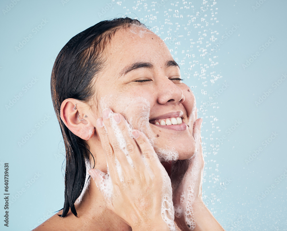 Skincare, shower soap and happy woman cleaning in studio isolated on a blue background. Water splash