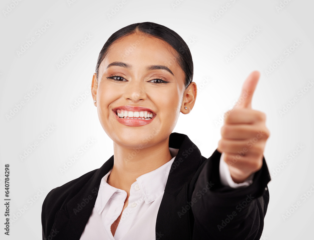 Happy business woman, portrait and thumbs up in success, winning or thank you against a studio backg