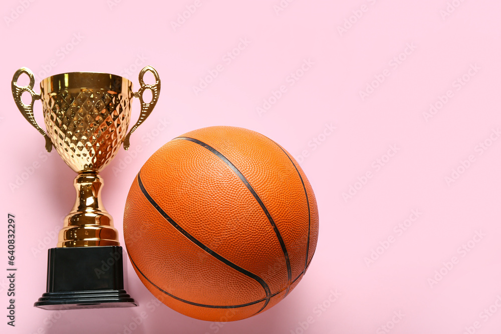 Gold cup with ball on pink background