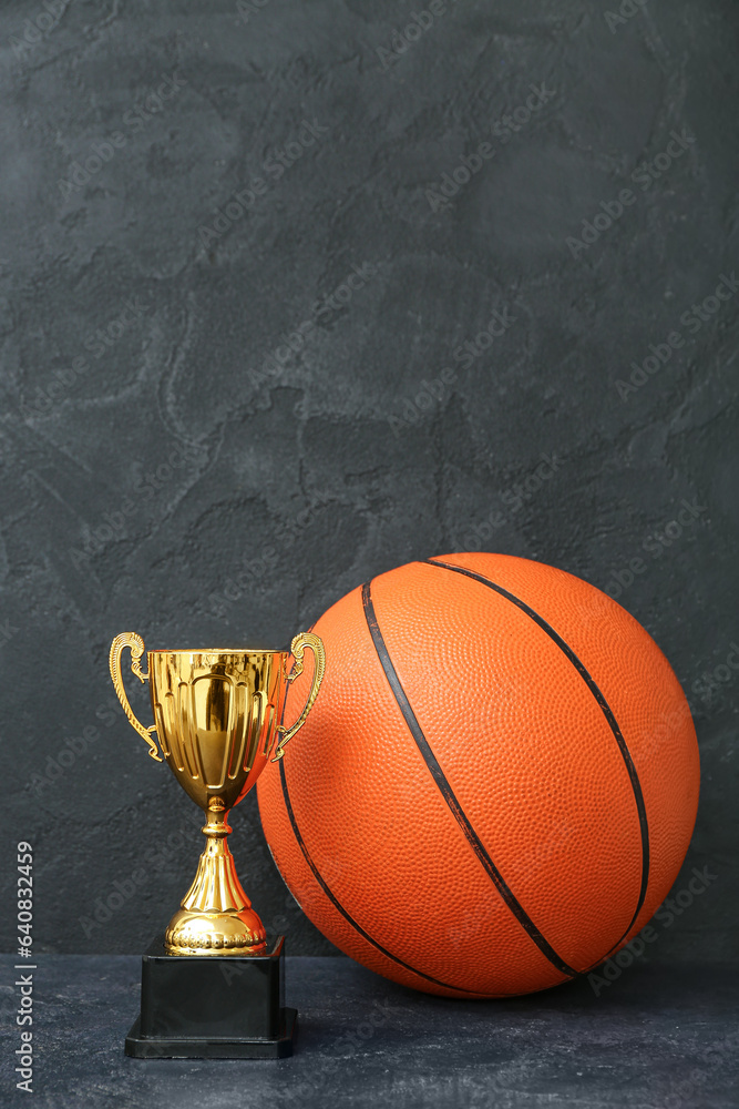 Gold cup with ball on dark background