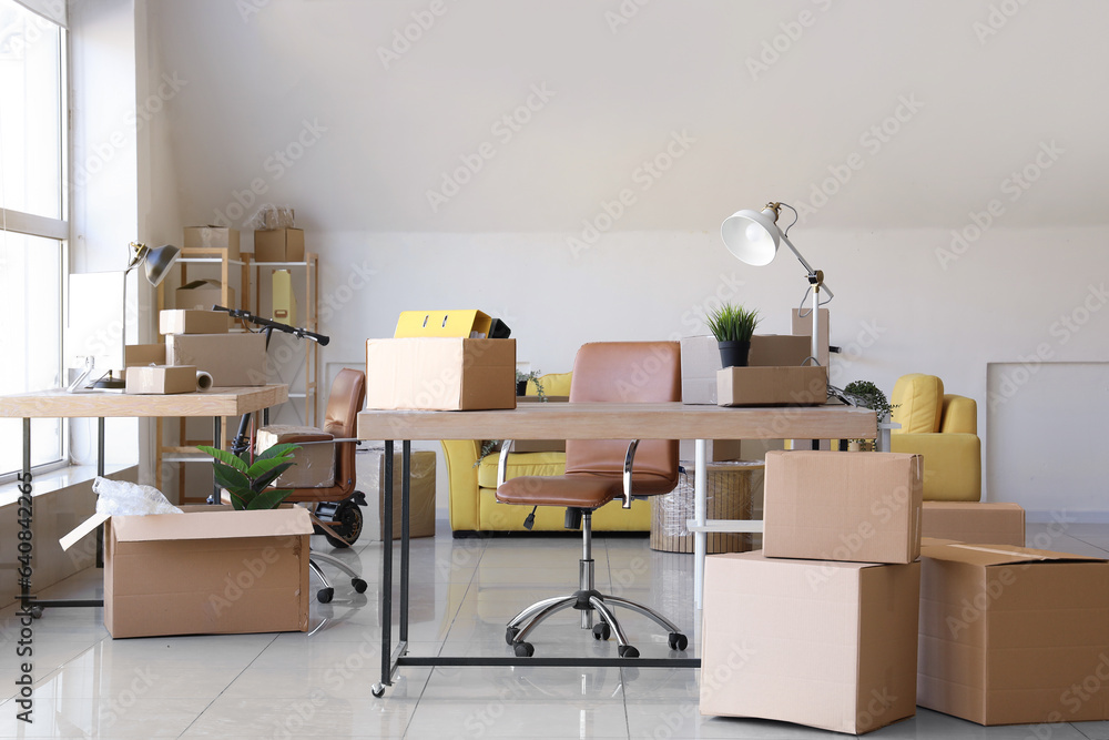 Interior of office with cardboard boxes on moving day