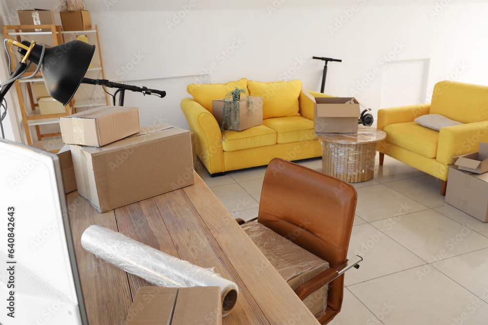 Interior of office with cardboard boxes on moving day