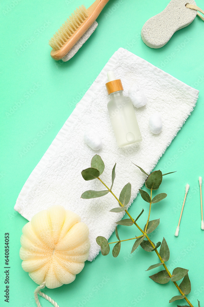 Composition with different bath supplies and eucalyptus branch on color background